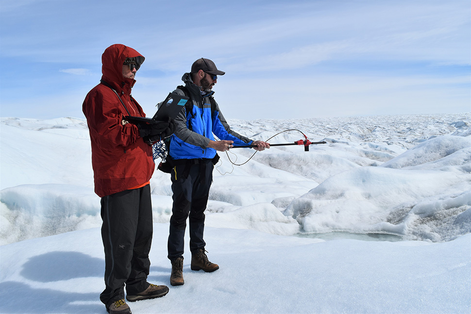 Lamont’s Marco Tedesco (right) measures the intensity and spectra of sunlight reflected off of ice in a spot near Kangerlussuaq in West Greenland.